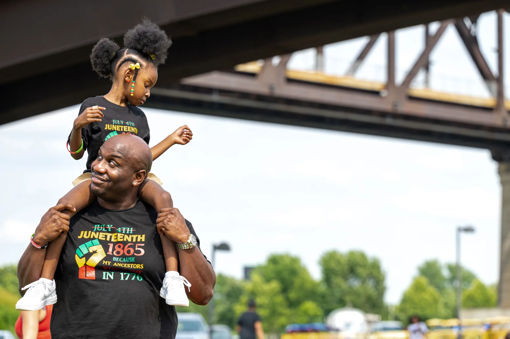 A young girl sits on a man's shoulders during the Louisville Juneteenth Festival on June 19, 2021, in Louisville, Kentucky. (Getty/Jon Cherry)
